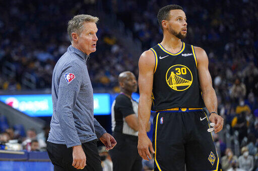 Golden State Warriors head coach Steve Kerr, left, and guard Stephen Curry (30) against the Charlotte Hornets during an NBA basketball game in San Francisco, Wednesday, Nov. 3, 2021. (AP Photo/Jeff Chiu)