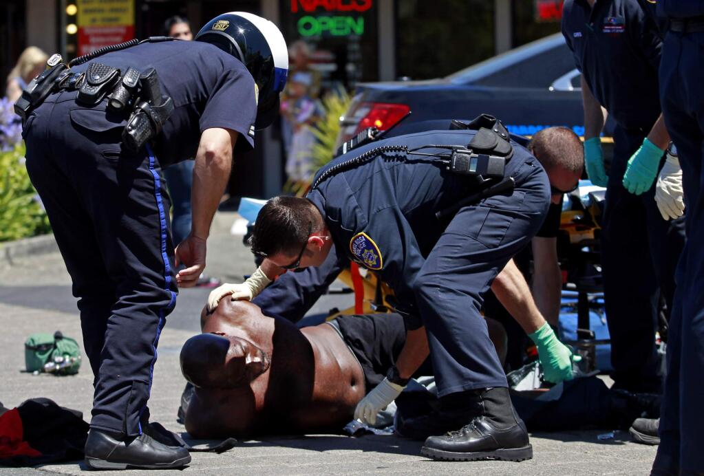 A suspect is taken into custody after a robbery at Bennett Valley Jewelers on Yulupa Ave. in Santa Rosa, Thursday, July 10, 2014. (Beth Schlanker / The Press Democrat)
