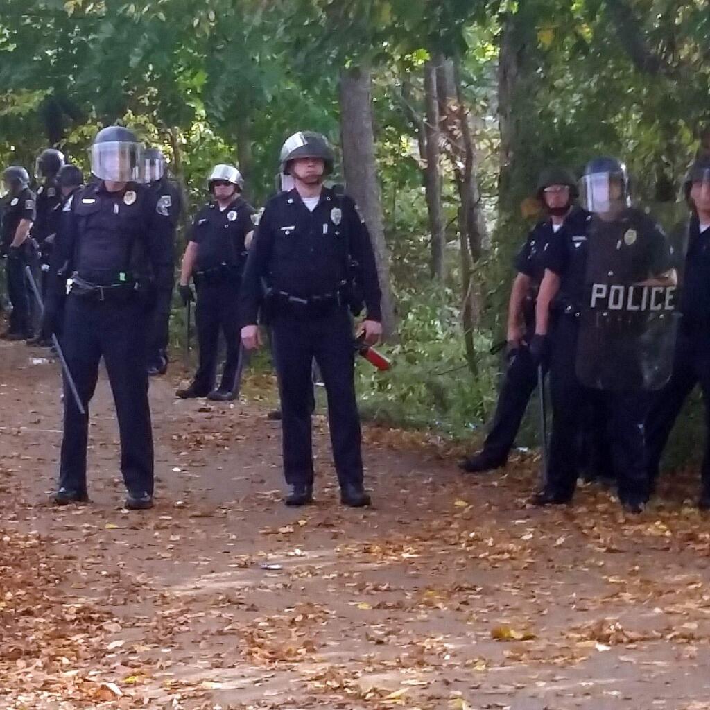 In this photo provided by Seth Meyer police officers line up. Local police, firefighters and ambulances in New Hampshire responded to large crowds of students as the annual Pumpkin Festival is underway near Keene State College Saturday, Oct. 18, 2014. Media report several people have been injured in an apparent Saturday afternoon melee. (AP Photo/Seth Meyer)
