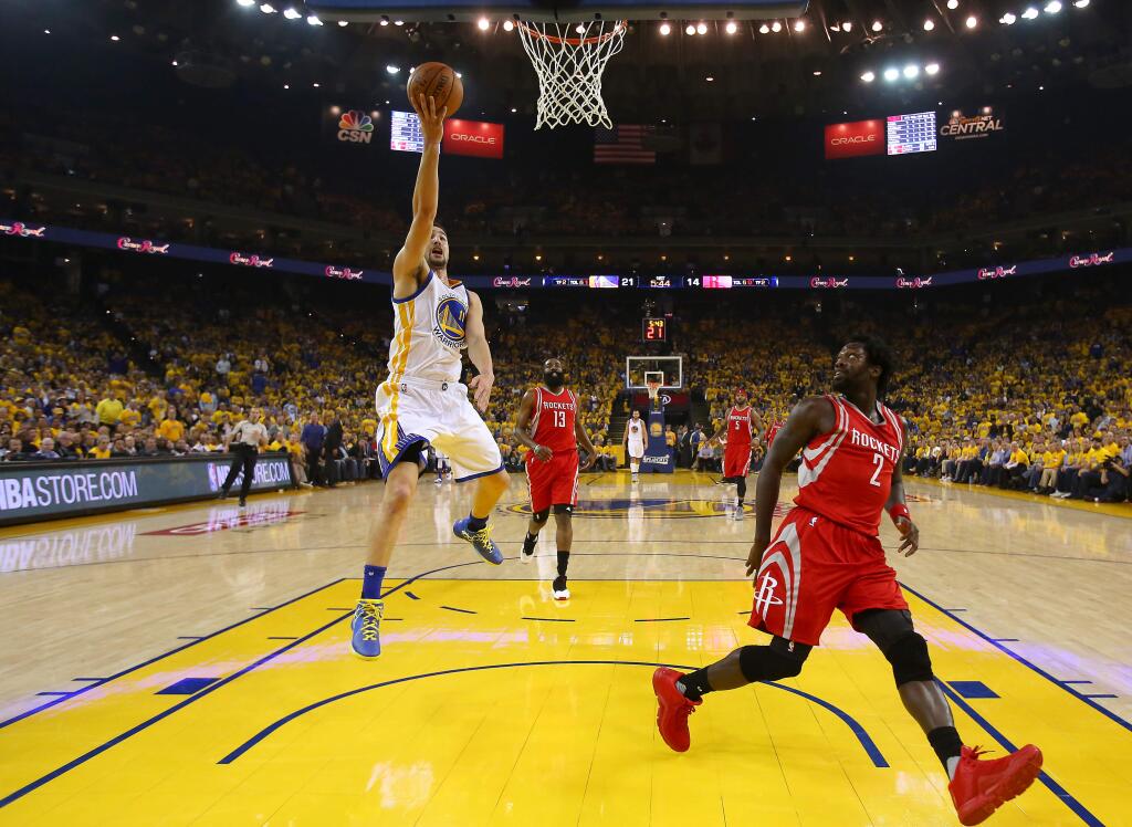 Golden State Warriors guard Klay Thompson goes up for a layup against Houston Rockets guard Patrick Beverley, during their game in Oakland on Wednesday, April 27, 2016. The Warriors defeated the Rockets 114-81.(Christopher Chung/ The Press Democrat)