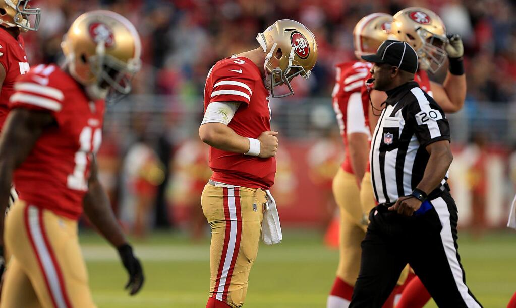 C.J. Beathard walks off the field dejected after throwing an interception late in the fourth quarter against the Arizona Cardinals, Sunday Nov. 5, 2017, essentially giving the 49ers their ninth loss against no wins. (Kent Porter / The Press Democrat) 2017