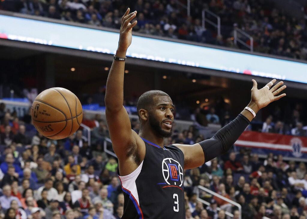 In this Dec. 28, 2015, file photo, Los Angeles Clippers guard Chris Paul reacts after dunking the ball during the first half against the Washington Wizards. (AP Photo/Carolyn Kaster, File)