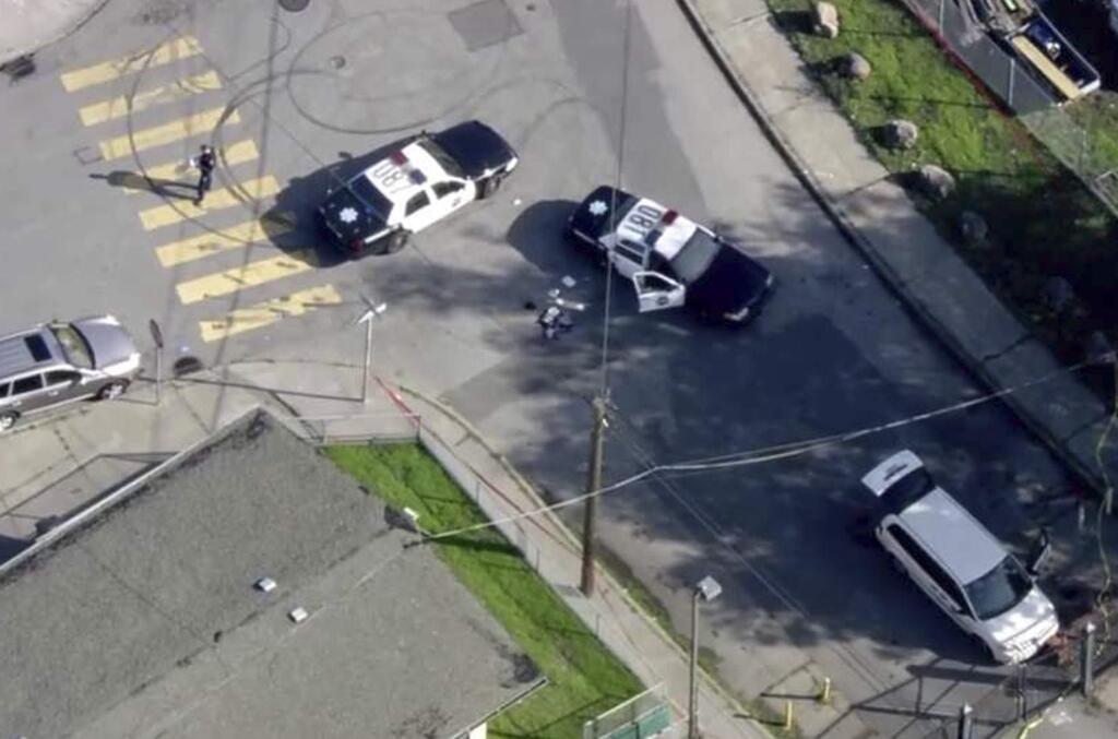 FILE - In this Dec. 1, 2017 file image taken from video provided by KTVU-TV, San Francisco police investigate an officer-involved shooting in the city's Bayview neighborhood in San Francisco. A Northern California woman has filed a civil rights lawsuit alleging a San Francisco police rookie wrongfully shot and killed her unarmed son while he fled from a stolen van he was driving earlier this month. Lawyers for the mother of 42-year-old Keita O'Neil filed the lawsuit Tuesday, Dec. 19, 2017, in federal court in San Francisco. (Courtesy of KTVU-TV via AP, File)