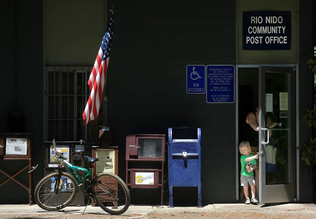 At the Rio Nido post office in the Russian River region, Seth Tincher 3 and his mother Josephine leave the facility after picking up their mail, Monday June 19, 2017. (Kent Porter / Press Democrat) 2017