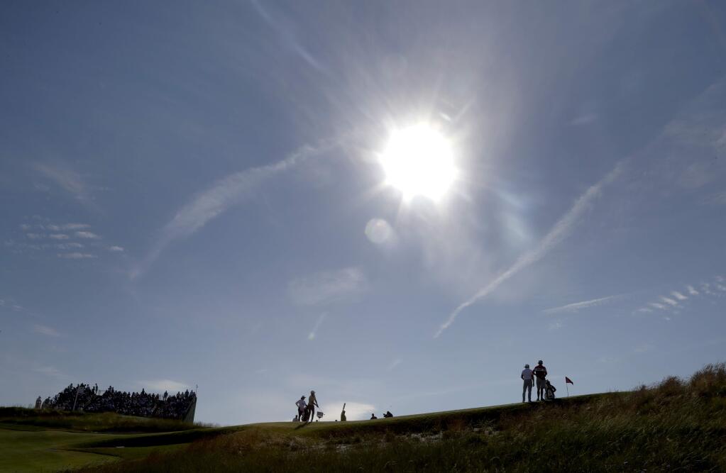 Russell Henley putts on the 11th hole during the third round of the U.S. Open Golf Championship, Saturday, June 16, 2018, in Southampton, N.Y. (AP Photo/Julio Cortez)