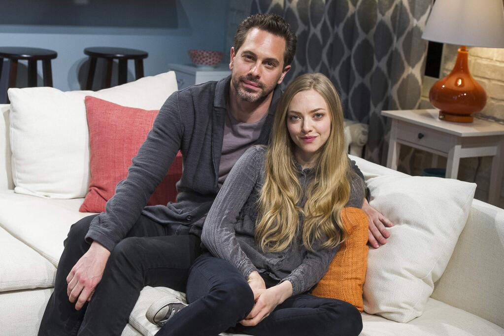 FILE - In this May 1, 2015, file photo, Thomas Sadoski, left, and Amanda Seyfried pose on the set of Neil LaBute's play 'The Way We Get By' at the Second Stage Theatre in New York. Sadoski told CBS 'Late Late Show' host James Corden on March 16, 2017, that he and Seyfried got married on March 12, 2017. (Photo by Charles Sykes/Invision/AP, File)