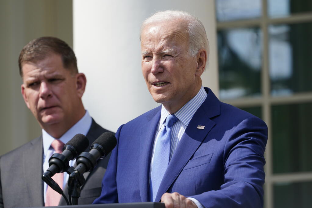 President Joe Biden, with Secretary of Labor Marty Walsh, left, speaks about a tentative railway labor agreement in the Rose Garden of the White House, Thursday, Sept. 15, 2022, in Washington. (AP Photo/Susan Walsh)