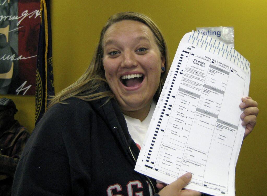 In this Oct. 20, 2008, photo provided by Nikola Halycyone Jordan, Jordan poses with her election ballot in Omaha, Neb. Jordan believes the selfies are a great way not only to share her views on the issues, but also to stress the importance of voting and being civically active. A Nebraska lawmaker added a provision to state election law in 2016 to allow ballot selfies. (Mari Zaporowski/Courtesy of Nikola Halycyone Jordan via AP)