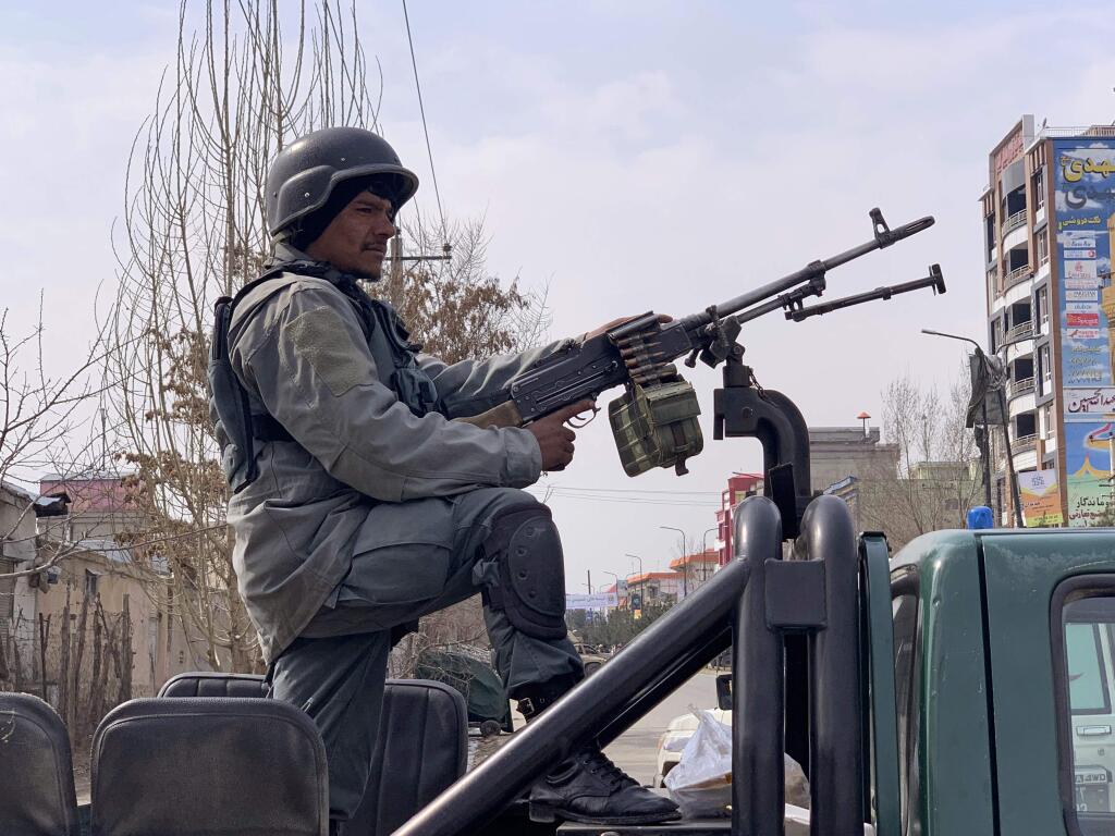 Afghan security personnel arrive at the site of an attack in Kabul, Afghanistan, Friday, March 6, 2020. Gunmen in Afghanistan's capital of Kabul attacked a remembrance ceremony for a minority Shiite leader on Friday, wounding more than a dozen of people, officials said. (AP Photo/Rahmat Gul)