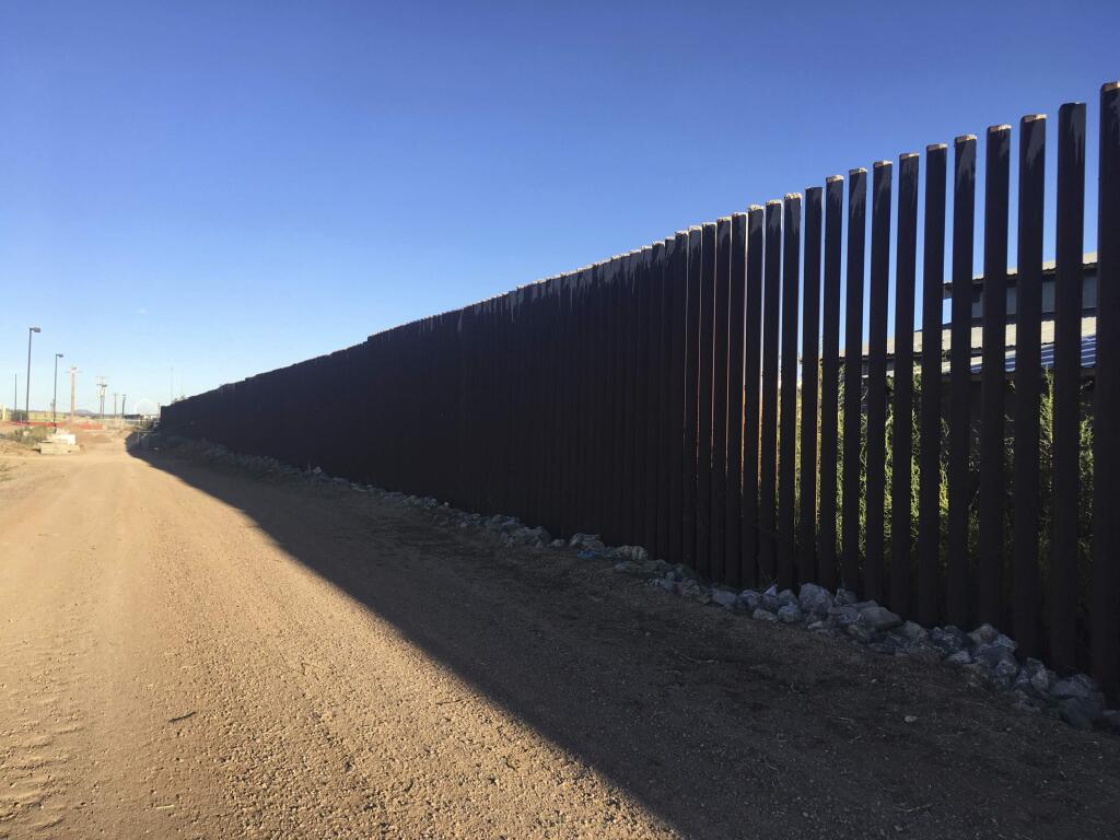 In this Oct. 3, 2018 photo, a border fence in Columbus, N.M., sits along the U.S.-Mexico border at sunset, (AP Photo/Russell Contreras)