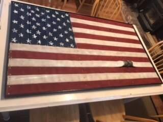 A flag made of fire hoses will be sold at auction in Santa Rosa on Monday.