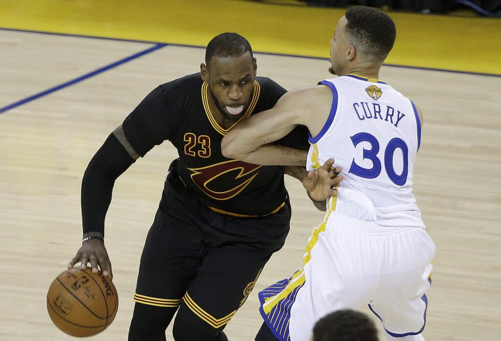 Cleveland Cavaliers forward LeBron James (23) dribbles against Golden State Warriors guard Stephen Curry (30) during the second half of Game 5 of basketball's NBA Finals in Oakland, Calif., Monday, June 13, 2016. (AP Photo/Marcio Jose Sanchez)