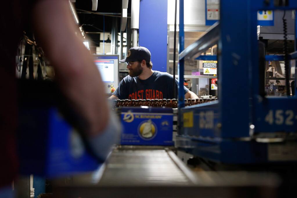 Bottler Jordan ball keeps an eye on the labeling line at North Coast Brewing Co. in Fort Bragg, California, on Thursday, March 10, 2016. (ALVIN JORNADA/ PD)