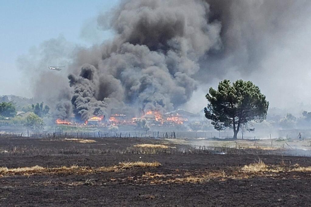 In this photo provided by the California Department of Forestry and Fire Prevention, the Nelson Fire burns Wednesday, June 17, 2020, near Oroville, Calif. Some residents of a Northern California county devastated by wildfire in 2018 are under evacuation orders because of a grass fire that has so far destroyed four homes. An evacuation order for parts of Oroville was issued after noon and the cause of the fire is under investigation. A 2018 wildfire in Butte County killed 85 people and destroyed more than 18,000 homes and buildings. (California Department of Forestry and Fire Prevention via AP)