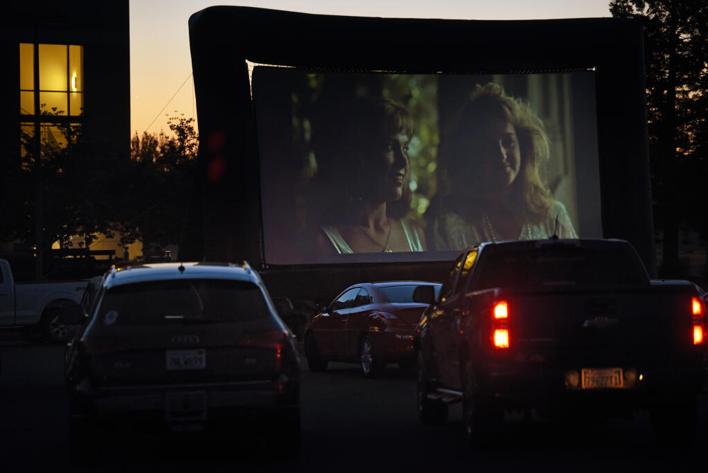 Attendees in their vehicles watching "Peggy Sue Got Married" during a drive-in movie fundraiser for Rep. Mike Thompson and the Santa Rosa-based Career Technical Education Foundation held at SOMO Village in Rhonert Park, Calif. on Saturday, May 1, 2021.(Photo: Erik Castro/for The Press Democrat)