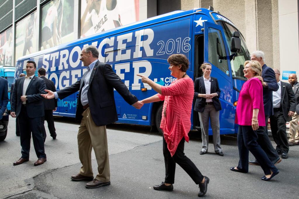 Democratic Vice Presidential candidate, Sen. Tim Kaine, D-Va., his wife Anne Holton, Democratic presidential candidate Hillary Clinton, and former President Bill Clinton, board their campaign bus after finishing a rally at McGonigle Hall at Temple University in Philadelphia, Friday, July 29, 2016. Clinton and Kaine will begin a three day bus tour. (AP Photo/Andrew Harnik)