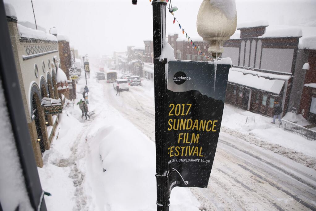 Heavy snow falls along Main Street during the 2017 Sundance Film Festival on Monday, Jan. 23, 2017, in Park City, Utah. (Photo by Danny Moloshok/Invision/AP)
