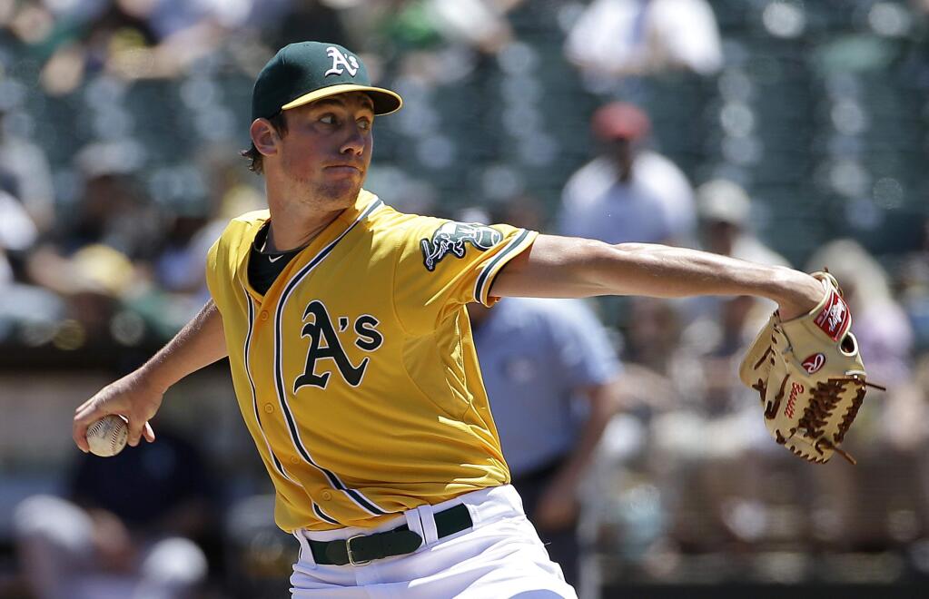 Oakland Athletics pitcher Chris Bassitt throws against the Seattle Mariners during the first inning of a game in Oakland, Sunday, July 5, 2015. (AP Photo/Jeff Chiu)