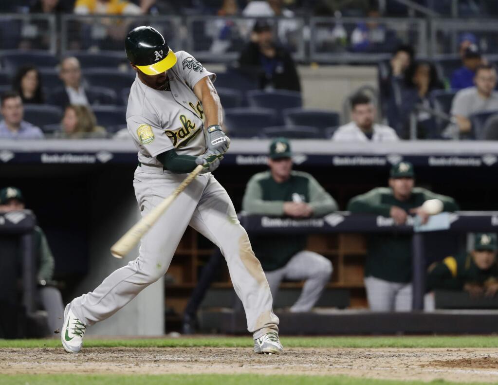 The Oakland Athletics' Marcus Semien hits a three-run double during the ninth inning against the New York Yankees on Friday, May 11, 2018, in New York. (AP Photo/Frank Franklin II)