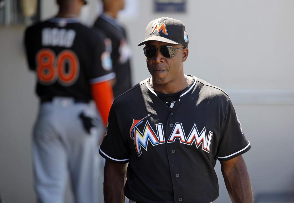 Miami Marlins hitting coach Barry Bonds walks in the dugout during a spring training game against the Minnesota Twins in Fort Myers, Fla., Friday, March 11, 2016. (AP Photo/Patrick Semansky)