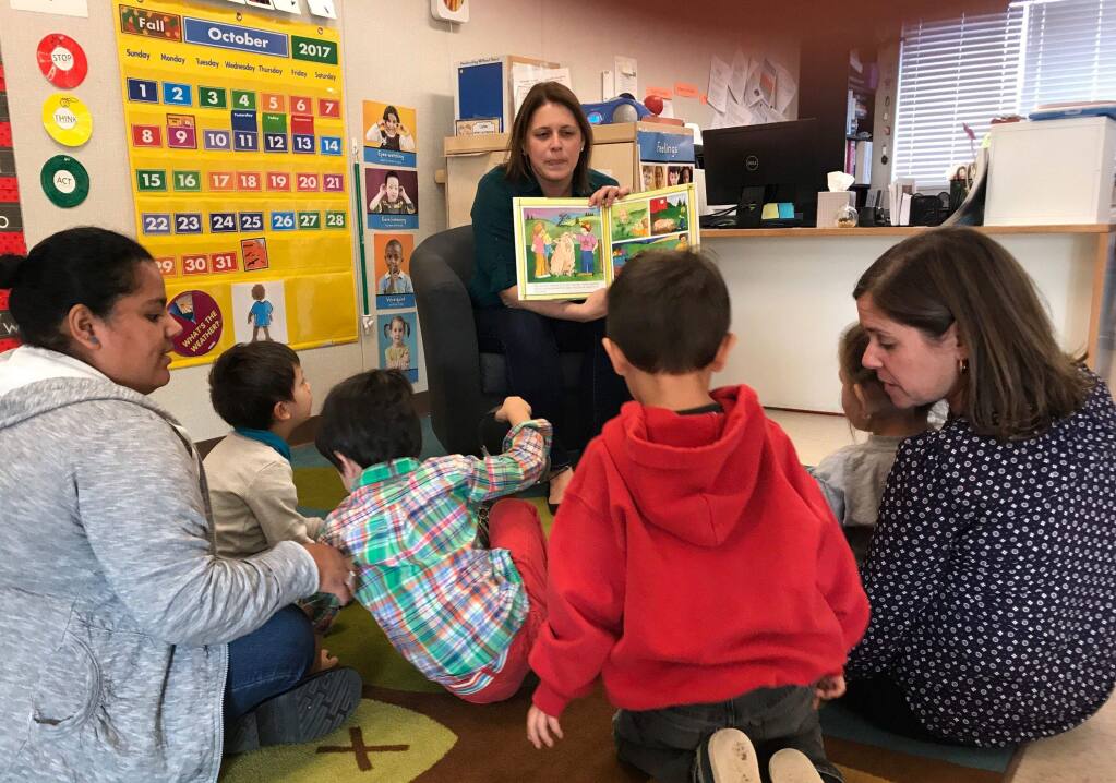 Kelly Bass Seibel, Petaluma Health center's director of business development and partnership, reads to kids at North Bay Children's Center.