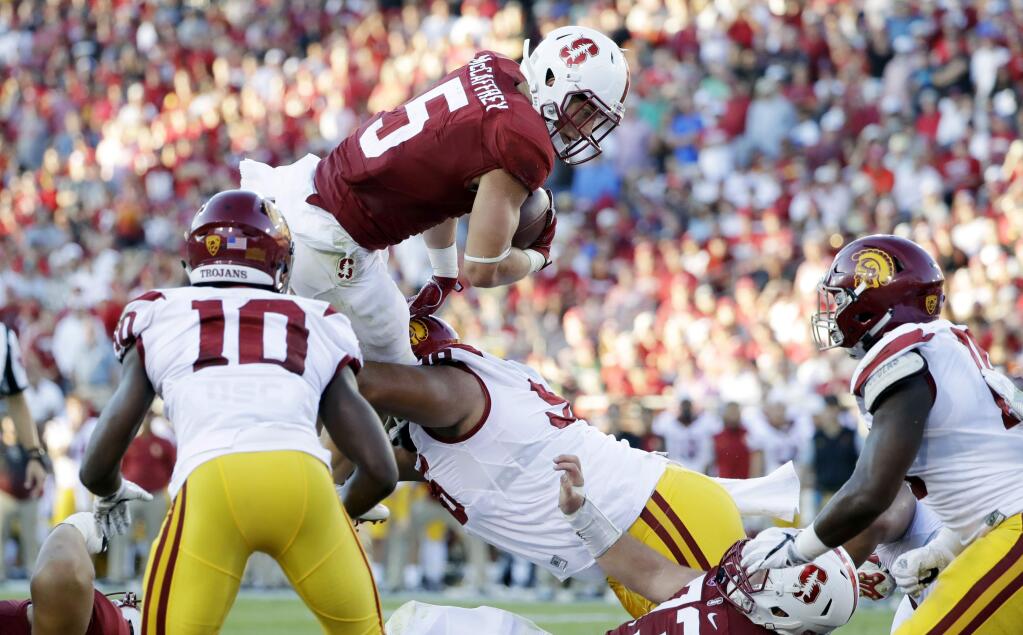 Stanford running back Christian McCaffrey (5) leaps over the line of scrimmage trying to score near the end zone against USC during the first half Saturday, Sept. 17, 2016, in Stanford. (AP Photo/Marcio Jose Sanchez)
