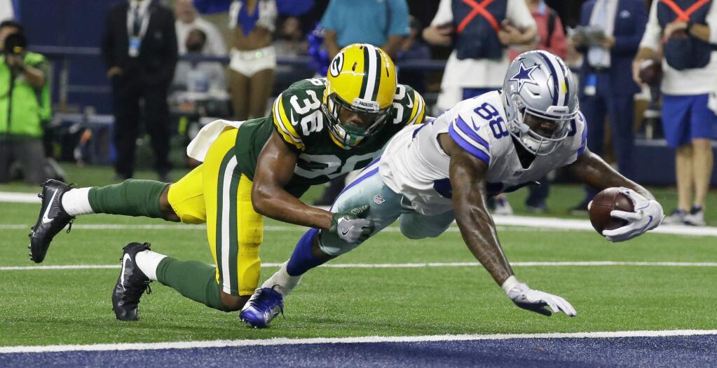 Dallas Cowboys wide receiver Dez Bryant (88) dives into the end zone for a touchdown after catching a pass as Green Bay Packers cornerback LaDarius Gunter (36) tackles him during the second half of an NFL divisional playoff football game Sunday, Jan. 15, 2017, in Arlington, Texas. (AP Photo/LM Otero)