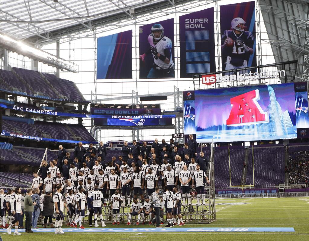 The New England Patriots assemble for their team photo in U.S. Bank Stadium Saturday, Feb. 3, 2018, in Minneapolis. The Patriots are scheduled to face the Philadelphia Eagles in the NFL Super Bowl 52 football game Sunday. (AP Photo/Mark Humphrey)