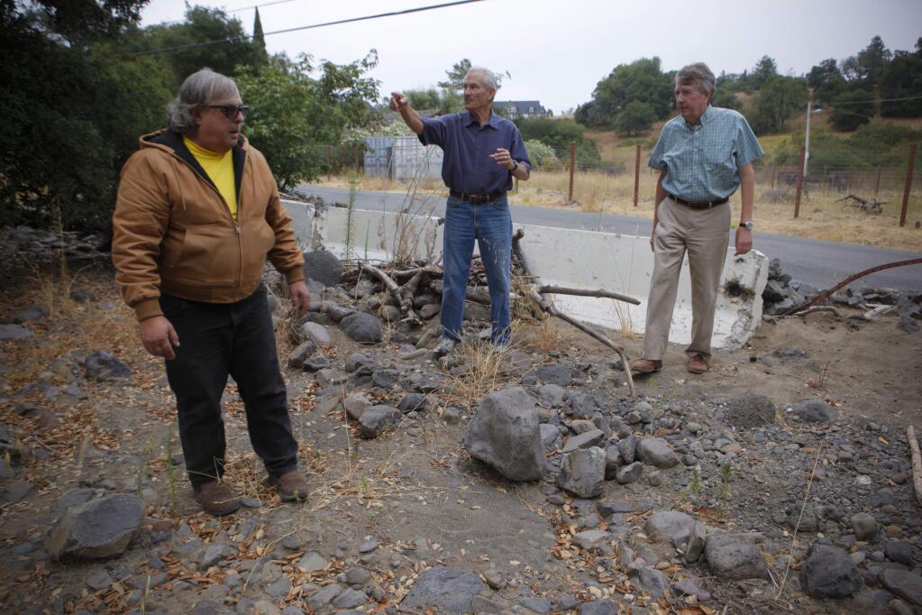 Petaluma, CA, USA. Tuesday, August 08, 2017._ Local residents Rick Savel and John FitzGerald show Petaluma City Councilman Mike Healy the area around Copeland Creek in Penngrove where water crests and often crosses Lichau Road causing flooding. (CRISSY PASCUAL/ARGUS-COURIER STAFF)