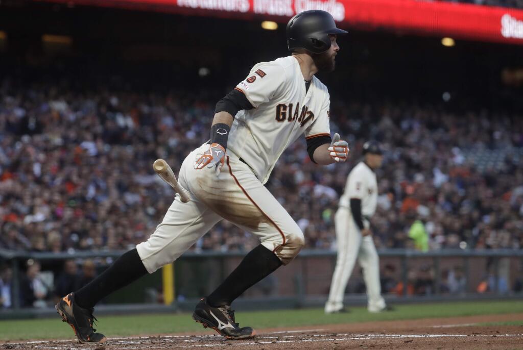 San Francisco Giants' Brandon Belt watches his single that scored Brandon Crawford against the Philadelphia Phillies during the third inning of a baseball game in San Francisco, Thursday, Aug. 8, 2019. (AP Photo/Jeff Chiu)