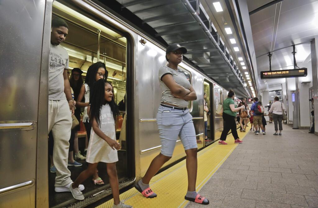 Passengers leave the No. 1 train at the South Ferry Station, Tuesday June 27, 2017, in New York. The station reopened Tuesday, nearly five years after it was flooded by Superstorm Sandy in October 2012. (AP Photo/Bebeto Matthews)