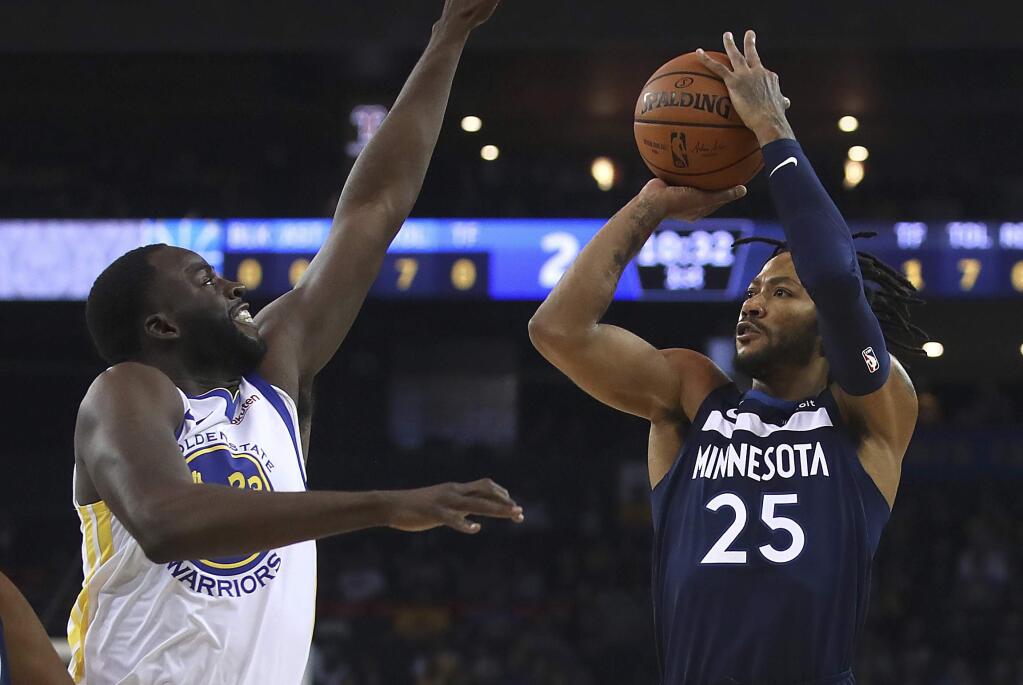 The Minnesota Timberwolves' Derrick Rose, right, shoots against the Golden State Warriors' Draymond Green during the first half of a preseason game Saturday, Sept. 29, 2018, in Oakland. (AP Photo/Ben Margot)