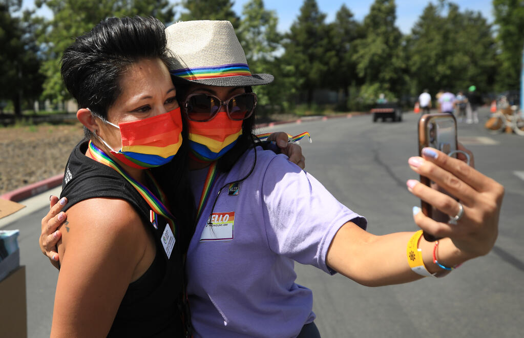 Katherine Wong of Windsor takes a selfie with Grace Villafuerte, Saturday, June 5, 2021 at the Sonoma County Pride drive-thru parade, at Graton Casino and Resort.  (Kent Porter / The Press Democrat) 2021