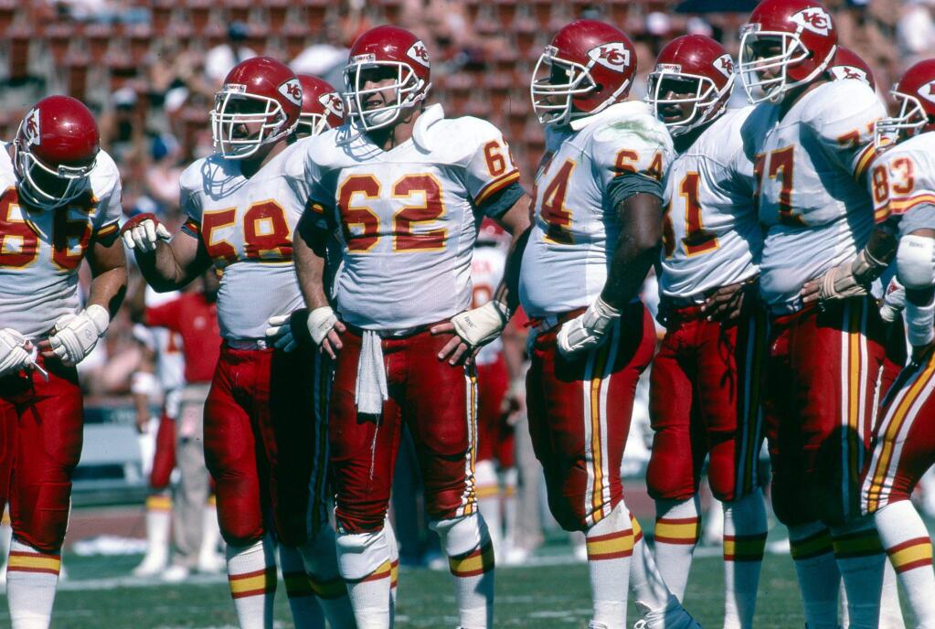 Kansas City Chiefs tackle Dan Doubiago (66), Arland Thompson (58), guard James Harvey (64) and tackle Steve Rogers (77) huddle up during an NFL game against the Los Angeles Raiders in Los Angeles on October 4, 1987. The Raiders defeated the Chiefs 35-17 in a replacement game during the 1987 NFL players strike. (AP Photo/NFL Photos)