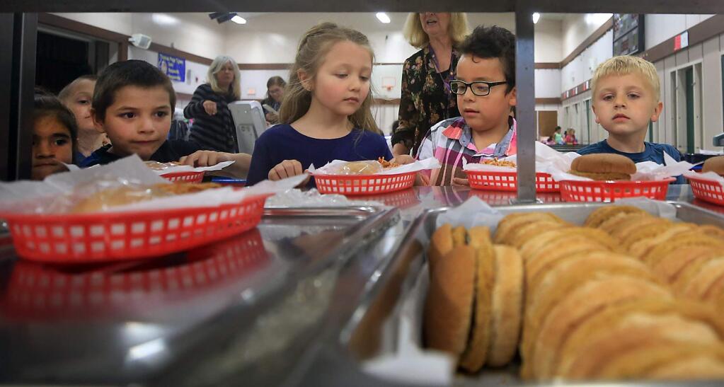 Thomas Page Academy kindergartners line up for a healthy lunch in the school's multi-use room in Cotati, Thursday May 11, 2017. (Kent Porter / The Press Democrat) 2017