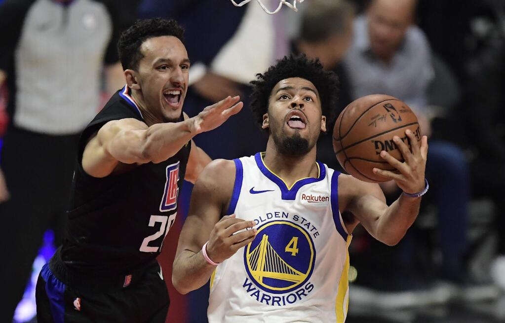 Golden State Warriors guard Quinn Cook, right, shoots as Los Angeles Clippers guard Landry Shamet defends during the second half in Game 6 of a first-round playoff series Friday, April 26, 2019, in Los Angeles. The Warriors won 129-110. (AP Photo/Mark J. Terrill)
