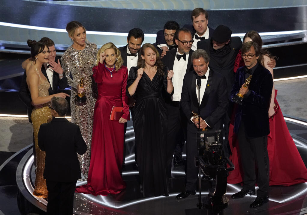 The cast and crew of "CODA" accept the award for best picture at the Oscars on Sunday, March 27, 2022, at the Dolby Theatre in Los Angeles. (AP Photo/Chris Pizzello)