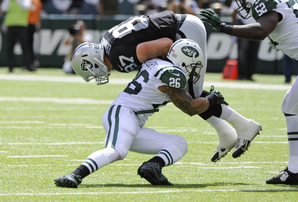 New York Jets' Dawan Landry (26) tackles Oakland Raiders' Brian Leonhardt (87) during the first half of an NFL football game Sunday, Sept. 7, 2014, in East Rutherford, N.J. (AP Photo/Bill Kostroun)