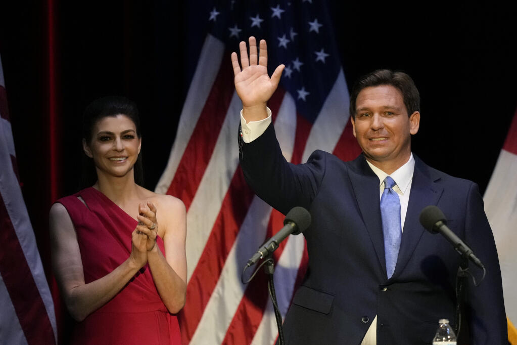 FILE - Florida's Republican Gov. Ron DeSantis waves as his wife Casey applauds, following a televised debate against Democratic opponent Charlie Crist, in Fort Pierce, Fla., Oct. 24, 2022. (AP Photo/Rebecca Blackwell, File)