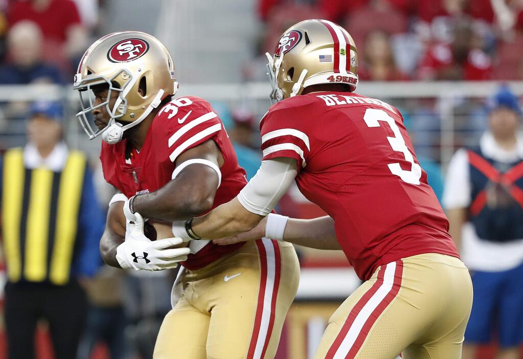 San Francisco 49ers running back Alfred Morris, left, takes a handoff from quarterback C.J. Beathard (3) during the first half of an NFL preseason football game against the Los Angeles Chargers in Santa Clara, Calif., Thursday, Aug. 30, 2018. (AP Photo/Tony Avelar)