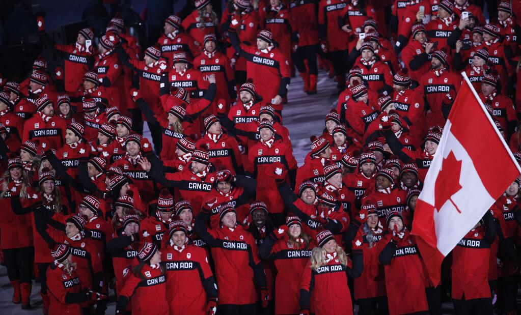 Athletes from Canada wave as they arrive during the opening ceremony of the 2018 Winter Olympics in Pyeongchang, South Korea, Friday, Feb. 9, 2018. (AP Photo/Christophe Ena)