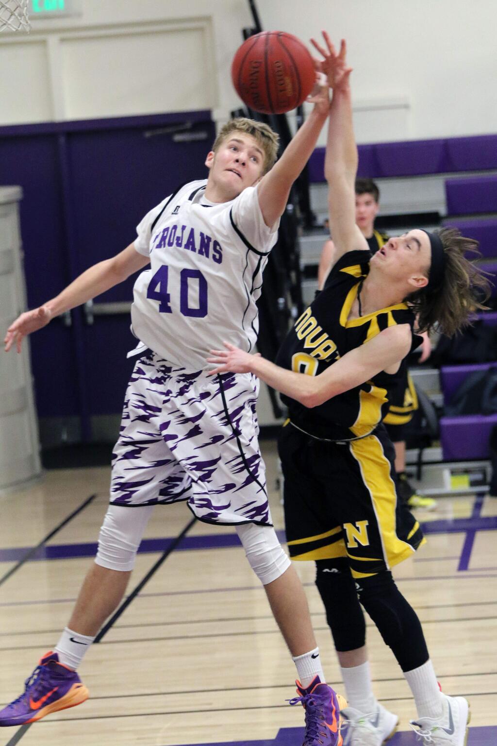 DWIGHT SUGIOKA/FOR THE ARGUS-COURIERPetaluma's Jack Anderson (40) battles for the basketball in his team's win over Novato Tuesday night.