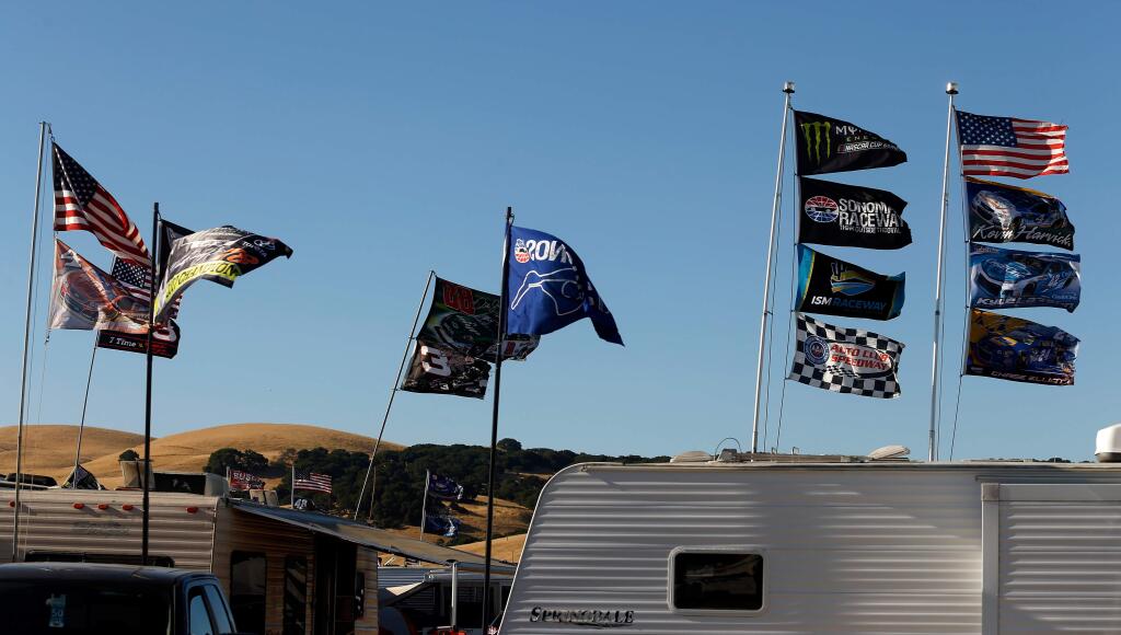 An assortment of flags fly above race fans' camper trailers and RV's parked at Sonoma Raceway's 50 Acres campground before this weekend's NASCAR Monster Energy Cup Series Toyota/Save Mart 350 race at Sonoma Raceway, in Sonoma, California, on Thursday, June 21, 2018. (Alvin Jornada / The Press Democrat)