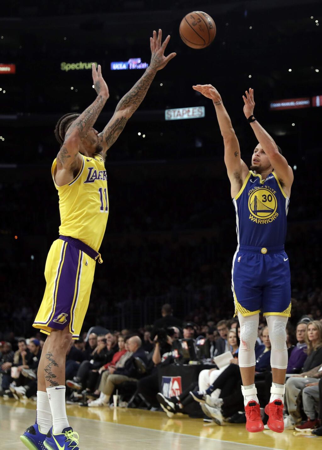 Golden State Warriors' Stephen Curry, right, shoots over Los Angeles Lakers' Michael Beasley during the second half of an NBA basketball game, Monday, Jan. 21, 2019, in Los Angeles. (AP Photo/Marcio Jose Sanchez)
