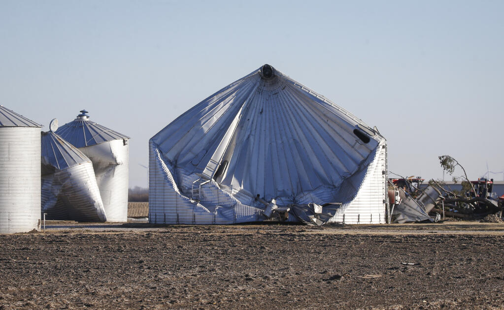 Damage to a grain bin is seen in Greene County, Iowa, on Thursday, Dec. 16, 2021, after a band of severe weather produced strong wind gusts and reports of tornadoes across much of the state Wednesday night. The storm caused property damage and downed power lines, leaving many Iowans without electricity. (Bryon Houlgrave/The Des Moines Register via AP)