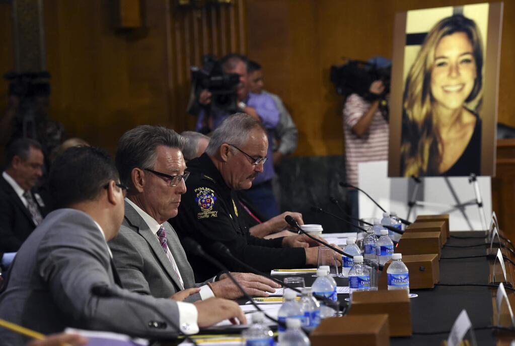 Jim Steinle, second from left, father of Kathryn Steinle, in photograph, testifies next to Montgomery County (Md.) Police Department. Chief J. Thomas Manger, right, before a Senate Judiciary hearing to examine the Administration's immigration enforcement policies, in Washington, Tuesday, July 21, 2015. Kathryn Steinle was killed on a San Francisco pier, allegedly by a man previously deported several times. (AP Photo/Molly Riley)