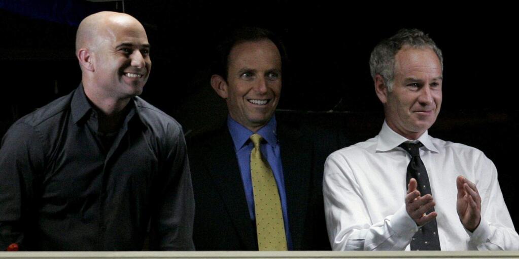 Former tennis players Andre Agassi, left, and John McEnroe, right, watch the match between Roger Federer and Andy Roddick with broadcaster Ted Robinson at the US Open tennis tournament in New York, Wednesday, Sept. 5, 2007. (AP Photo/Darron Cummings)