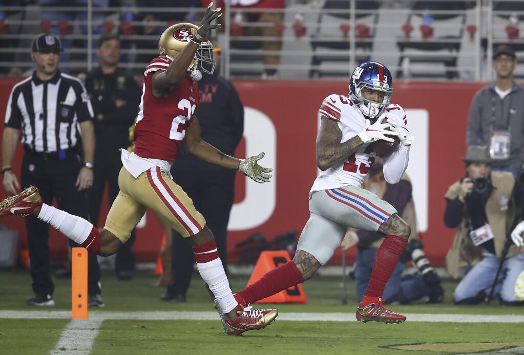 New York Giants wide receiver Odell Beckham Jr., right, catches a touchdown pass in front of San Francisco 49ers cornerback Ahkello Witherspoon during the second half in Santa Clara, Monday, Nov. 12, 2018. (AP Photo/Ben Margot)