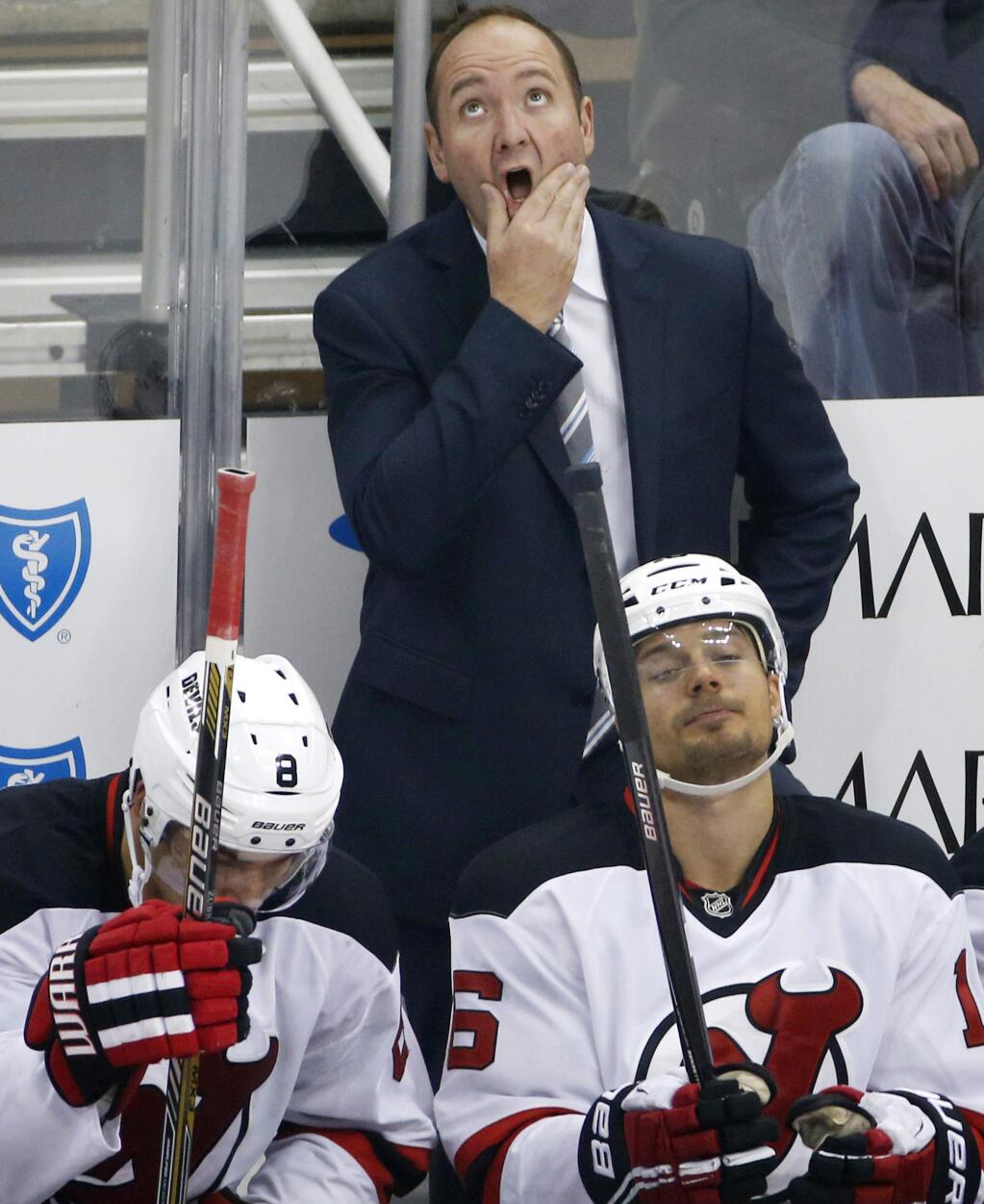 FILE - In this Oct. 28, 2014, file photo, New Jersey Devils head coach Peter DeBoer looks at the scoreboard during the first period of an NHL hockey game against the Pittsburgh Penguins in Pittsburgh. The Devils fired DeBoer on Friday, Dec. 26, 2014. (AP Photo/Gene J. Puskar, File)