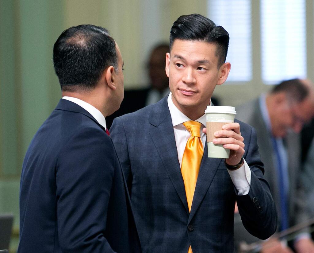 FILE--In this Sept. 13, 2017, file ph too, California Assemblyman Ash Kalra, D-San Jose, left, talks with fellow Democratic Assemblyman Evan Low, of Campbell, at the Capitol in Sacramento, Calif. Low says he authored a bill Thursday, April 19, 2018, to crack down on people selling conversion therapy as a way to change someone's sexual orientation because conversion therapy has been proven ineffective and harmful. (AP Photo/Rich Pedroncelli, file)